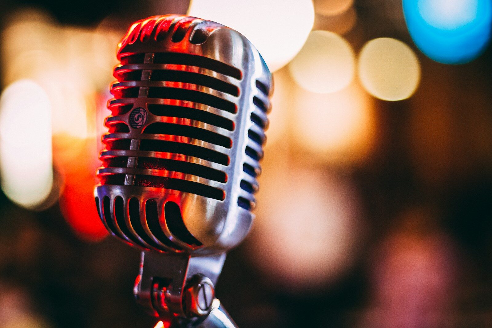 Close-up of a microphone positioned on a stage, ready for a performance or speech.